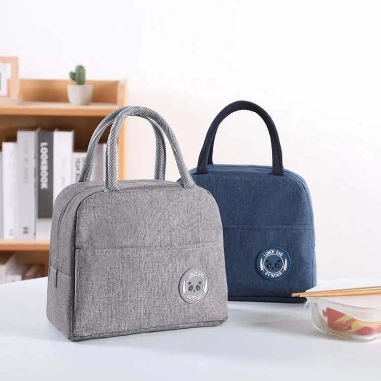 Two insulated lunch bags side by side: blue and gray, each with black handles and logo patch.