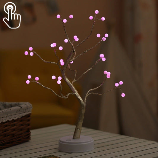 Copper wire pearl tree table lamp with pink LED lights on a white base