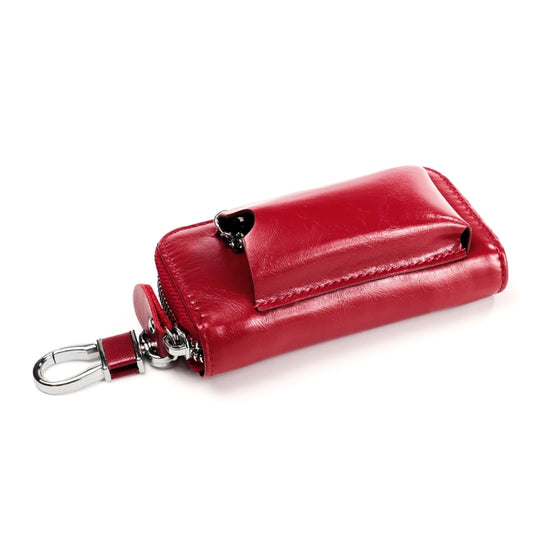 Red leather key case with snap-style flap, zipper edge, and key ring attachment