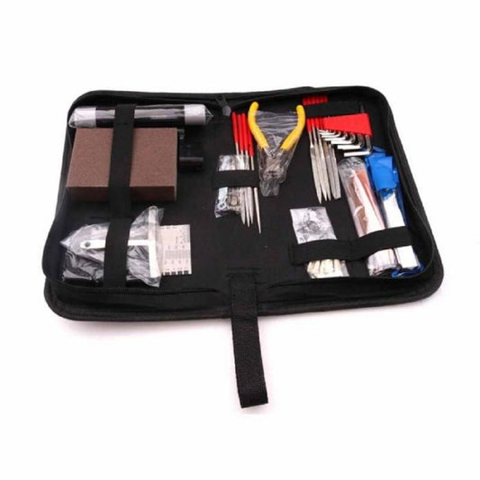 Guitar repair tool set laid out flat in black roll-up case, assorted gauges and tools