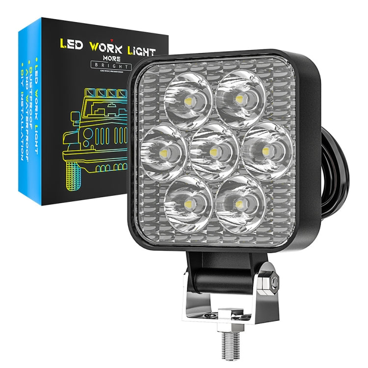 Black square LED auxiliary light with six lenses, shown with retail box