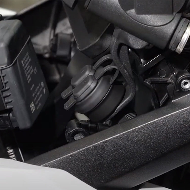 Motorcycle USB charger socket installed on bike dashboard area, black dual-port housing