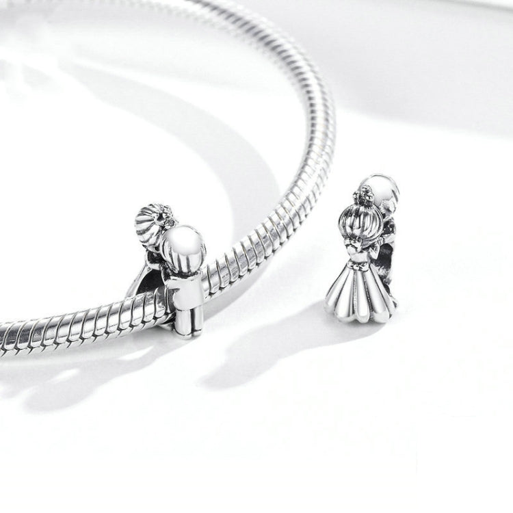 Sterling silver snake chain with girl and boy charms, close-up