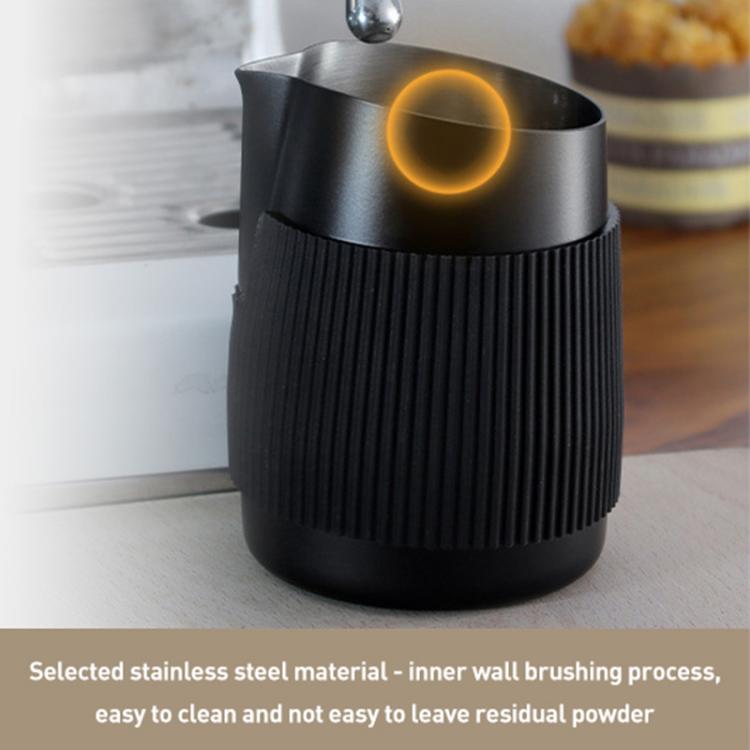 Black stainless latte art cup with ribbed sleeve and open metal interior