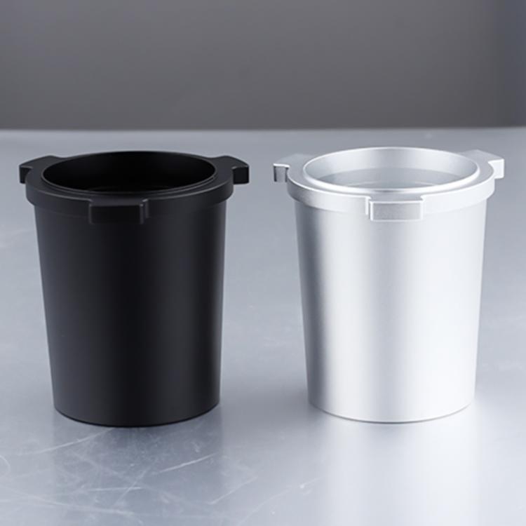 Coffee dosing cups in black and silver finishes, each with open top rim