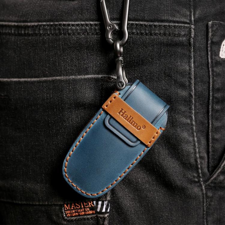 Blue leather key fob cover with stitched trim and metal keyring, on black jeans