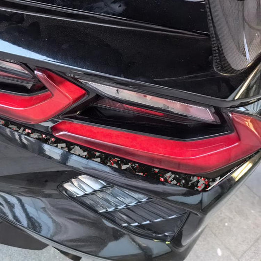 Taillight lower edge accent sticker with black carbon-fiber pattern and red flecks