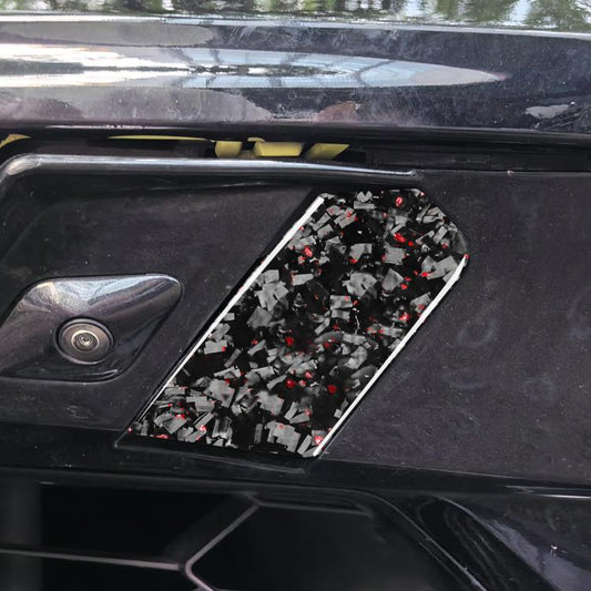 Trailer hook sticker installed on car panel; black with red foil shard design