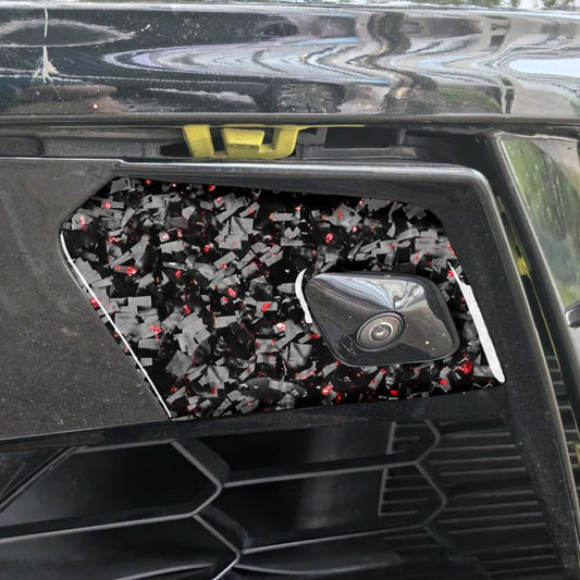 Car door radar decals installed, black with red foil shards, around radar sensor cutout