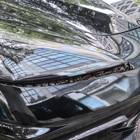 Carbon fiber look headlight trim sticker along front edge, red speckled foil detail