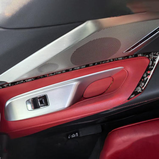 Installed carbon-fiber door accent stickers on red door panel near handle