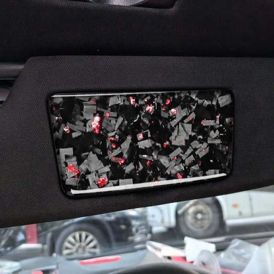 Black makeup mirror panel sticker with red foil confetti, installed on car door trim