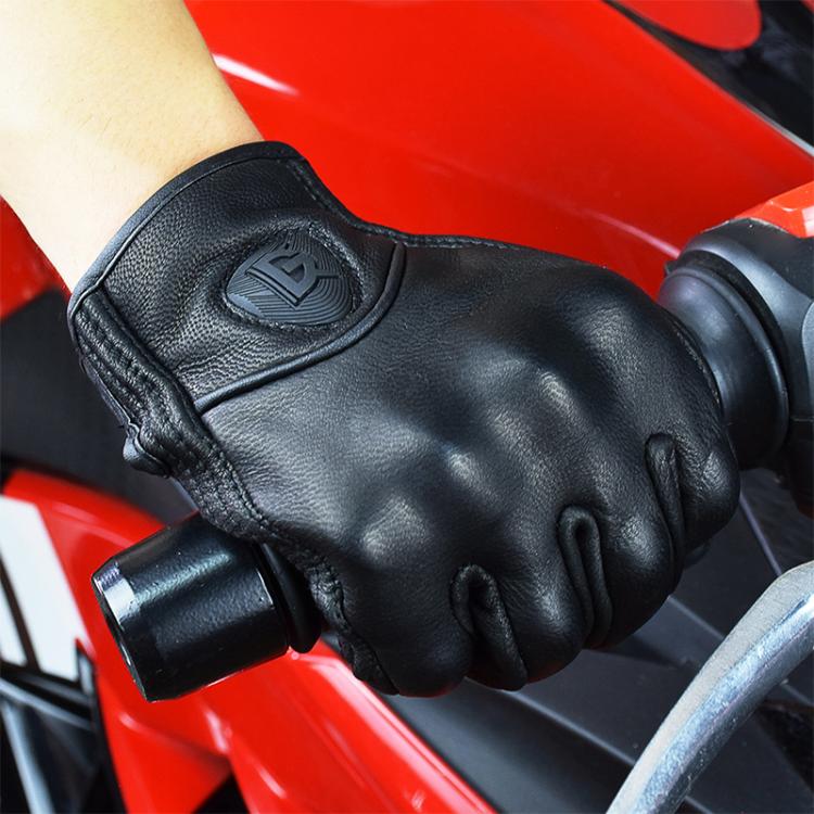 Black motorcycle riding glove on hand gripping a handlebar