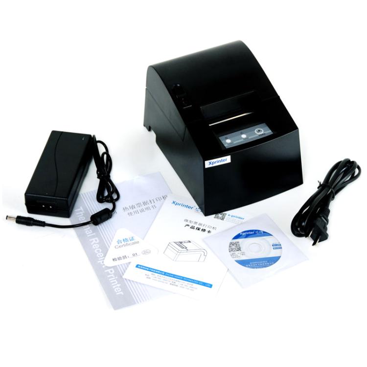 Black thermal receipt printer with power adapter, cables, and included papers