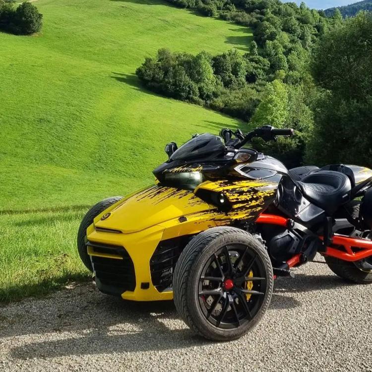 Smoked dashboard cowl on a Can-Am Spyder trike, black tinted front spoiler