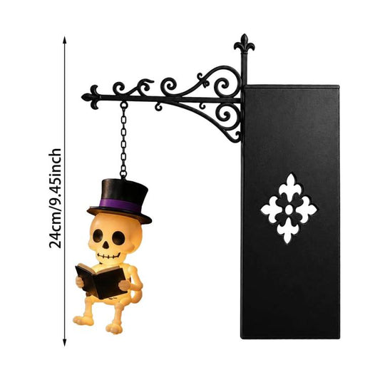 Hanging skull reading night light, orange skull and purple top hat on black bracket