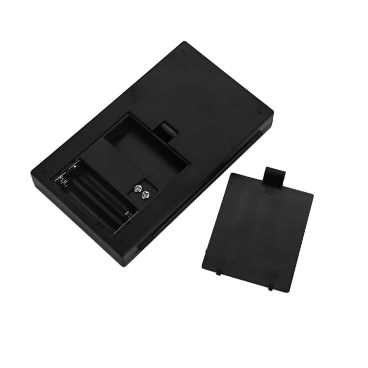 Portable digital jewelry scale with open battery compartment and removable cover panel