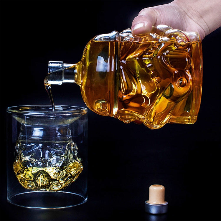 Crystal glass decanter bottle being poured, with silver cap and embossed body