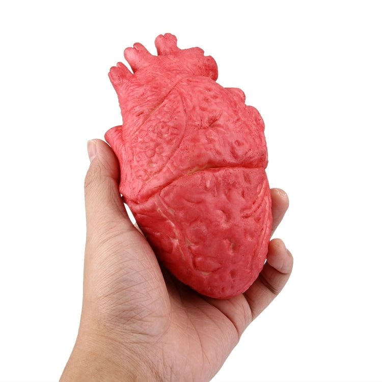 Handheld red fake heart prop with detailed vein-like texture