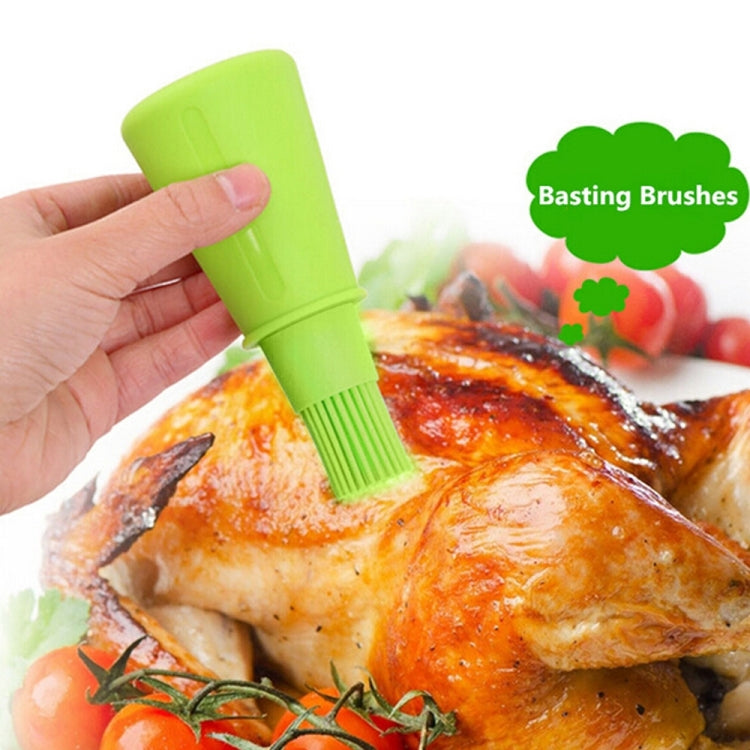 Green silicone basting brush with squeeze bottle and comb-style bristles