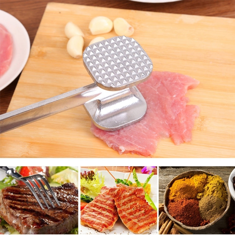 Meat tenderizer hammer with diamond-texture mallet head pressing on pork