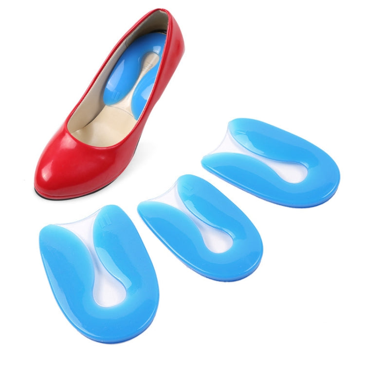 Blue U-shaped silicone heel pads inserted in shoes for heel cushioning