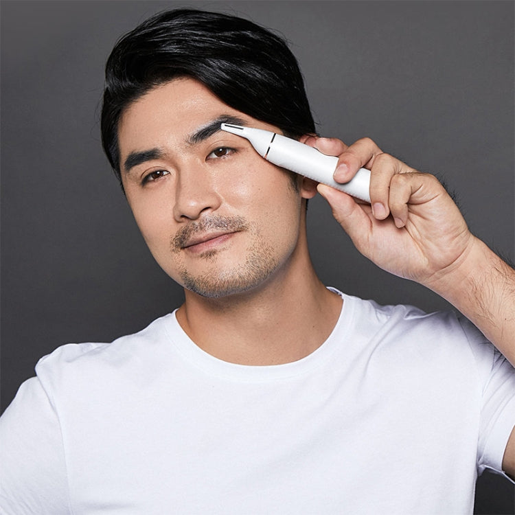 White nasal trimmer used at nostril area on person