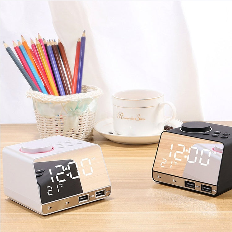 Two Bluetooth alarm clock speakers on desk, displaying time and icons