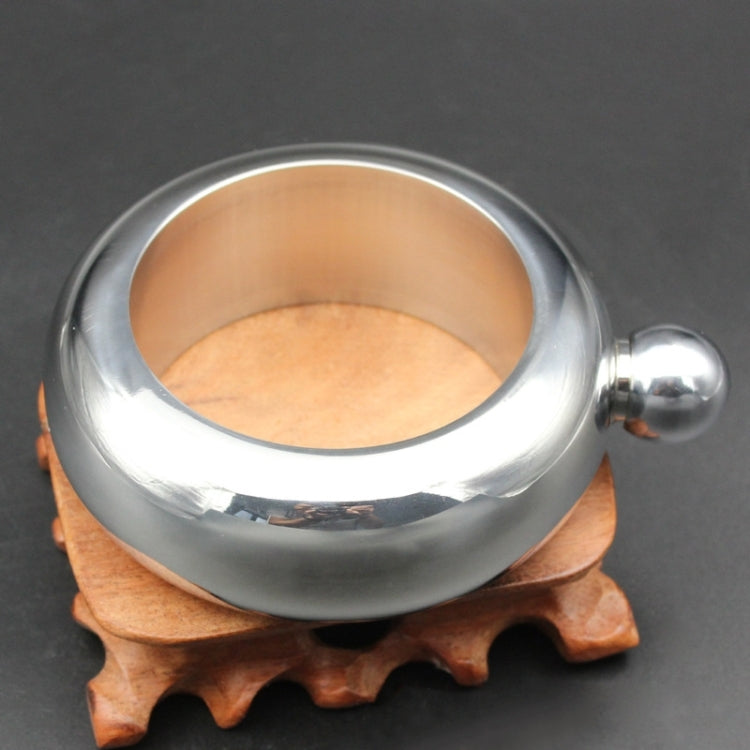 Silver stainless bracelet-style jug open on wooden stand with side ball handle