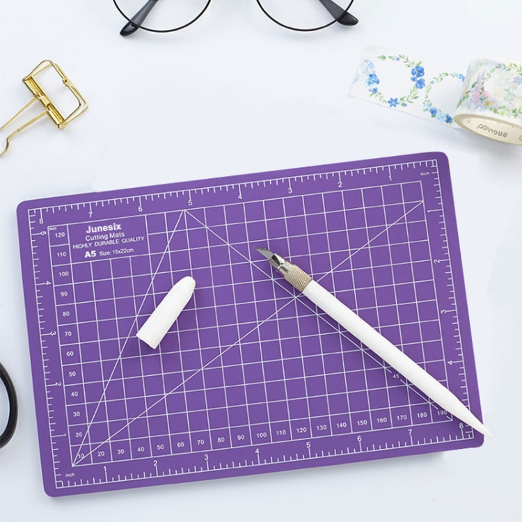 Purple A5 cutting mat with white chalk and pen-style craft blade tool