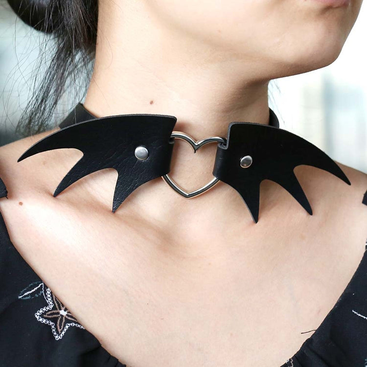 Black demon wing leather choker necklace with heart-shaped clasp and pointed wing tips