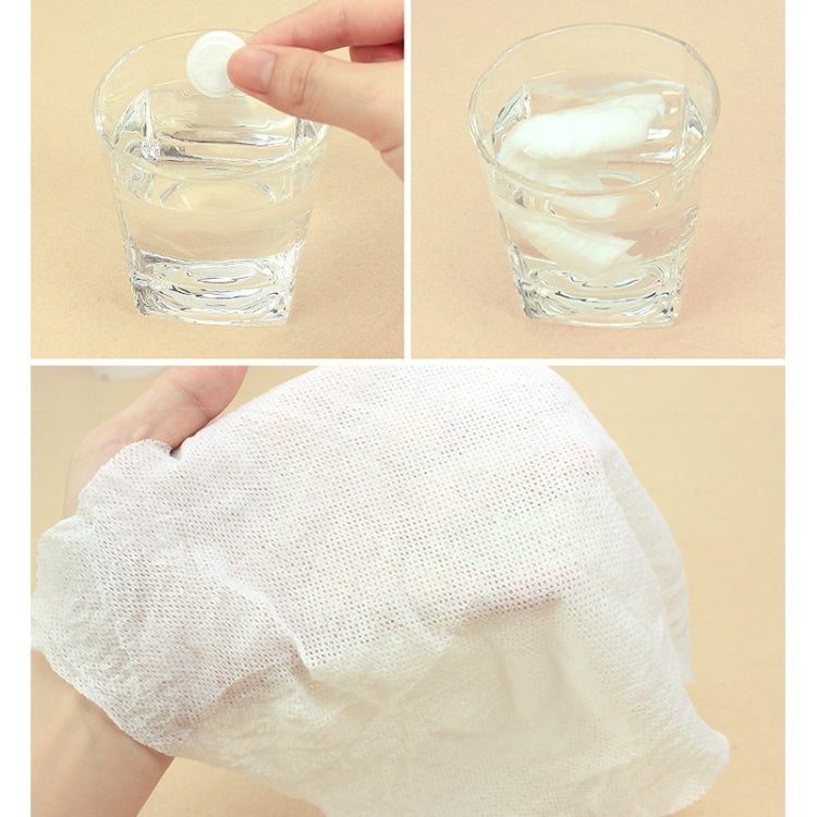 White disposable towel in hand with glass of water, travel compression face towel