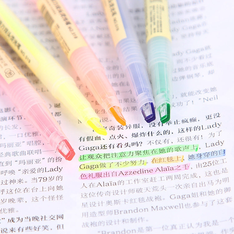 Yellow highlighter ink line on printed text with marker tip visible