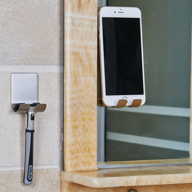 Stainless steel plug cord hook mounted on wall with charging cable attached