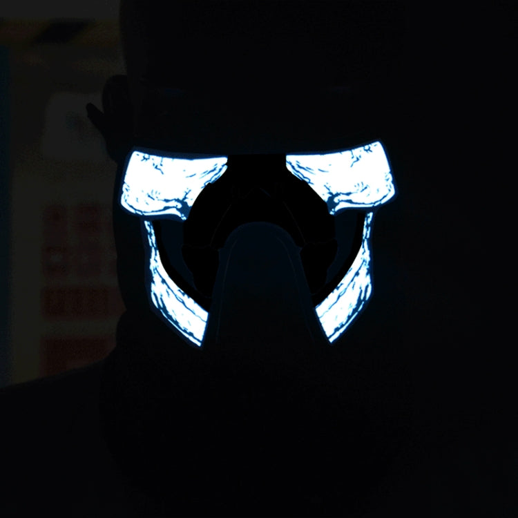 Blue-glowing skull LED face mask front view on black fabric