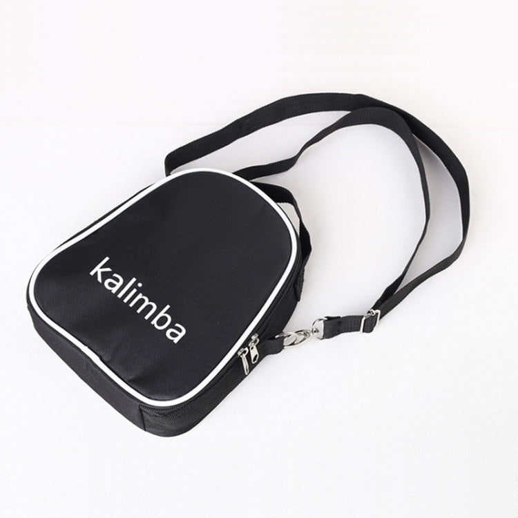 Kalimba carrying case with strap, black padded bag with 'kalimba' label on lid.