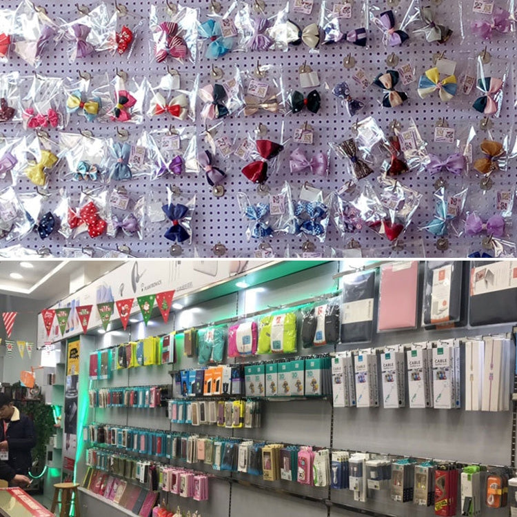 Pegboard retail display with chrome hooks supporting small items and gift bags