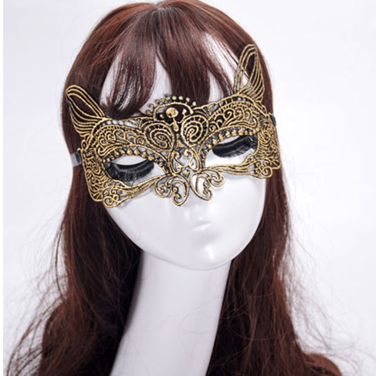 Gold cat king masquerade mask worn on face, with black eye coverings and filigree trim