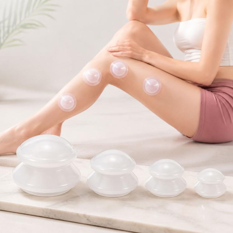 Clear silicone vacuum cupping cups on leg, four domed suction domes