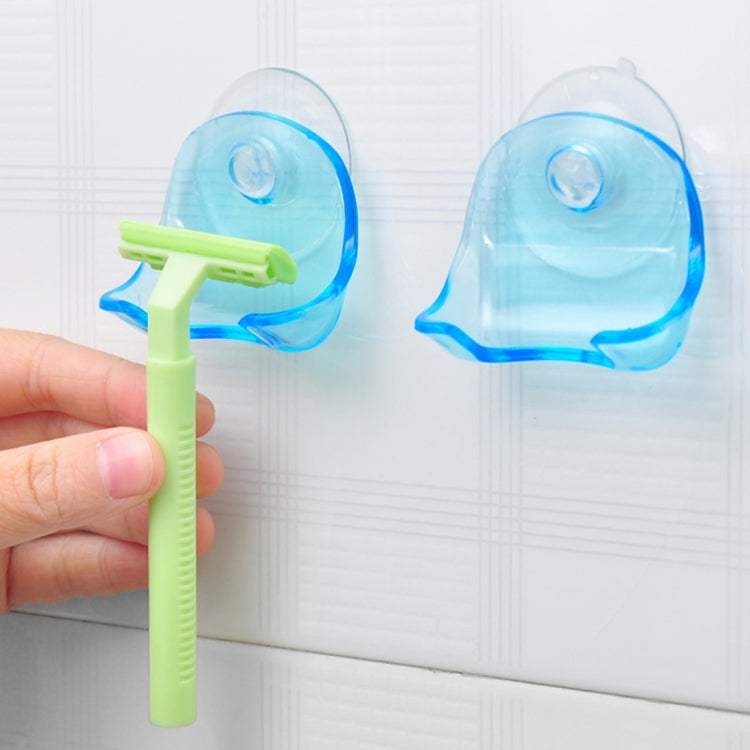 Set of two clear blue suction cup razor holders on wall, open front for blades