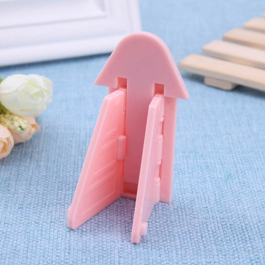 Pink triangular window lock stopper with inner bar and vertical hinge tabs.