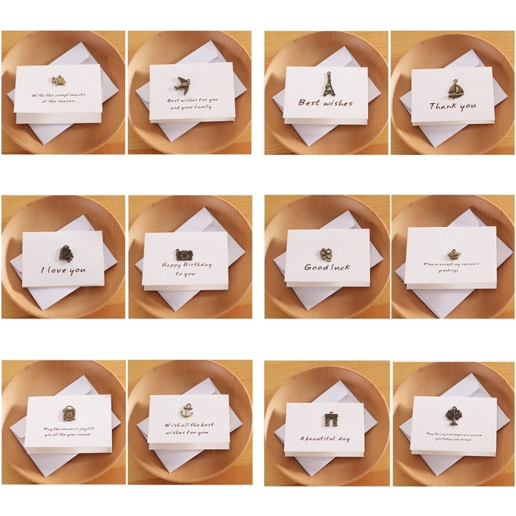 Set of mini folding greeting cards on display, each with different bronze charm and message