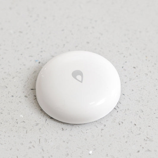White leak detector sensor with gray droplet emblem on countertop