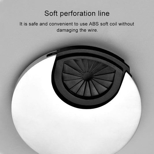 Round desk cable grommet cover with black vent insert, close-up view