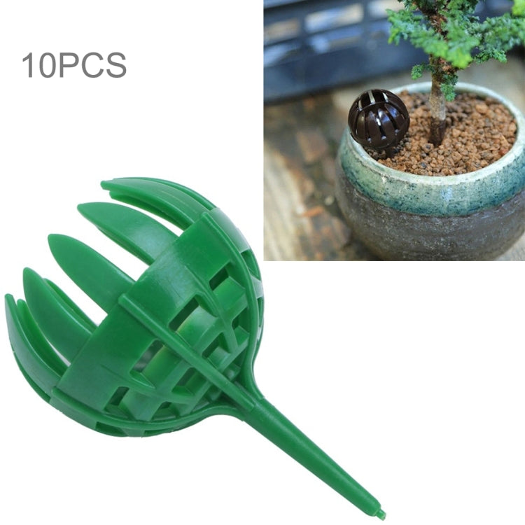 Green bonsai fertilizer applicator tool with long handle and circular perforated head