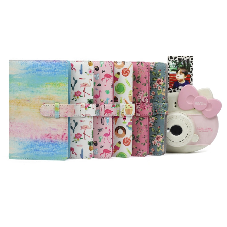 Assorted mini photo albums with colorful covers, including flamingo cactus patterns