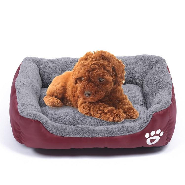 Gray fleece-lined wine red dog kennel mat with paw logo, featuring a resting brown puppy.
