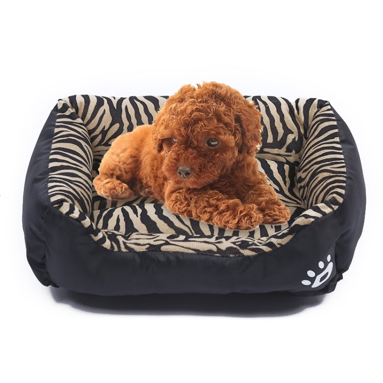 Amber zebra-print pet kennel mat with curled brown dog and black outer base, paw logo