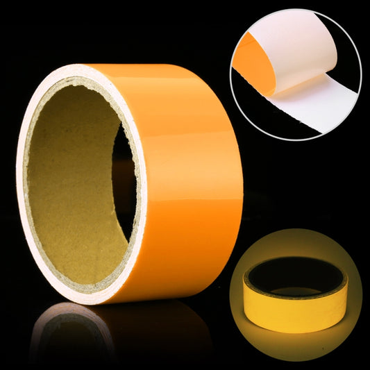 Luminous photoluminescent tape roll, orange glow tape with white backing edges.