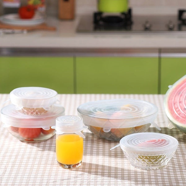 Set of translucent silicone sealing lids with pull tabs on glass food containers